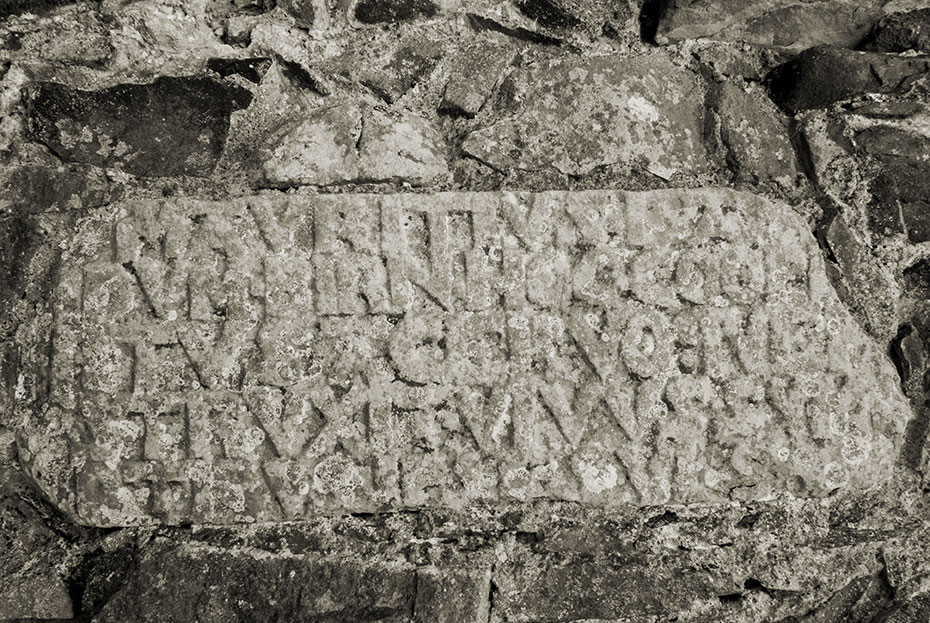 Latin inscription on stone set into south wall