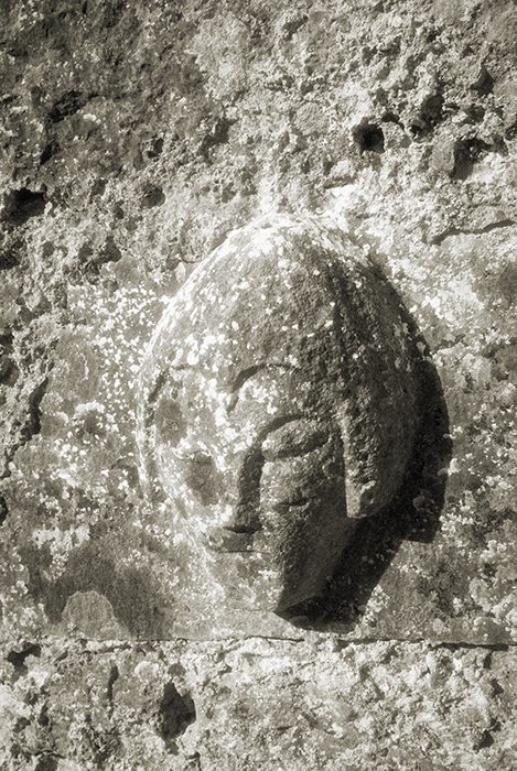 Carved head on the north wall of Carron Church